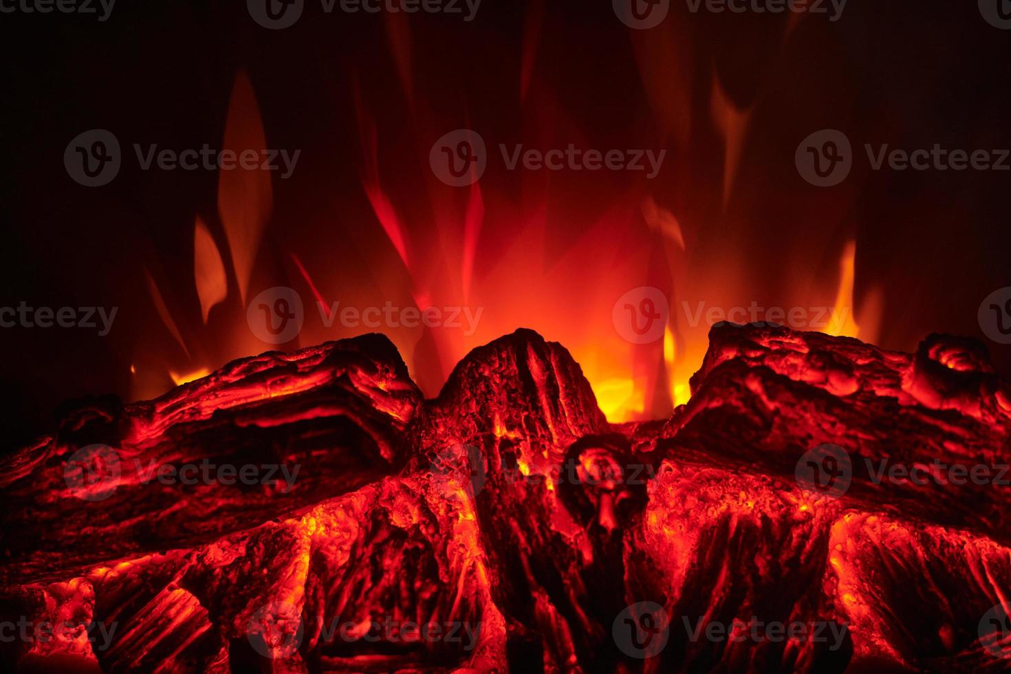 Electronic fireplace with red and yellow flame, close up. photo