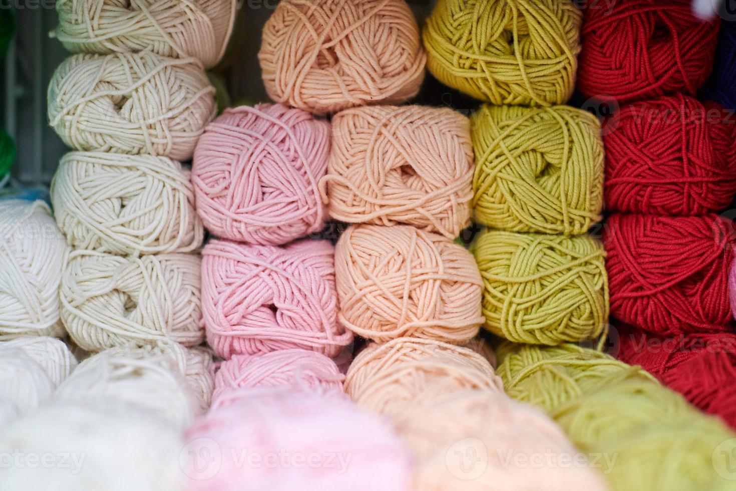 Yarns or balls of wool on shelves in store for knitting photo