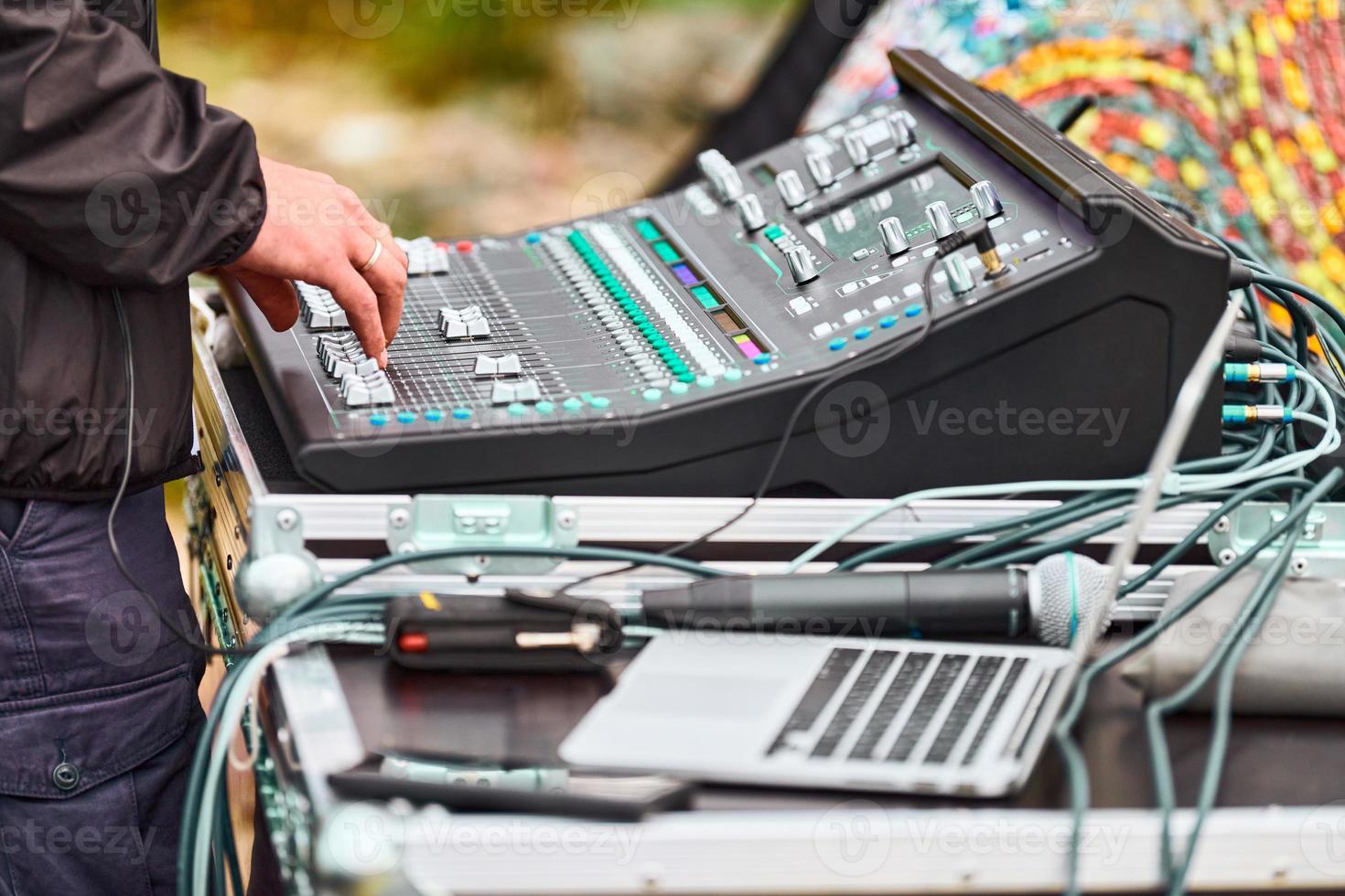 Sound engineer hands working on sound mixer at live concert, stage sound mixer, audio mix slider photo