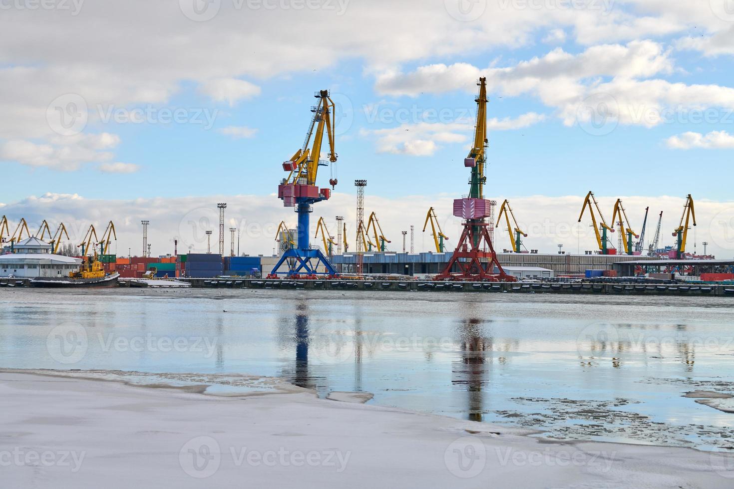 Moored ships and harbor cranes in port photo