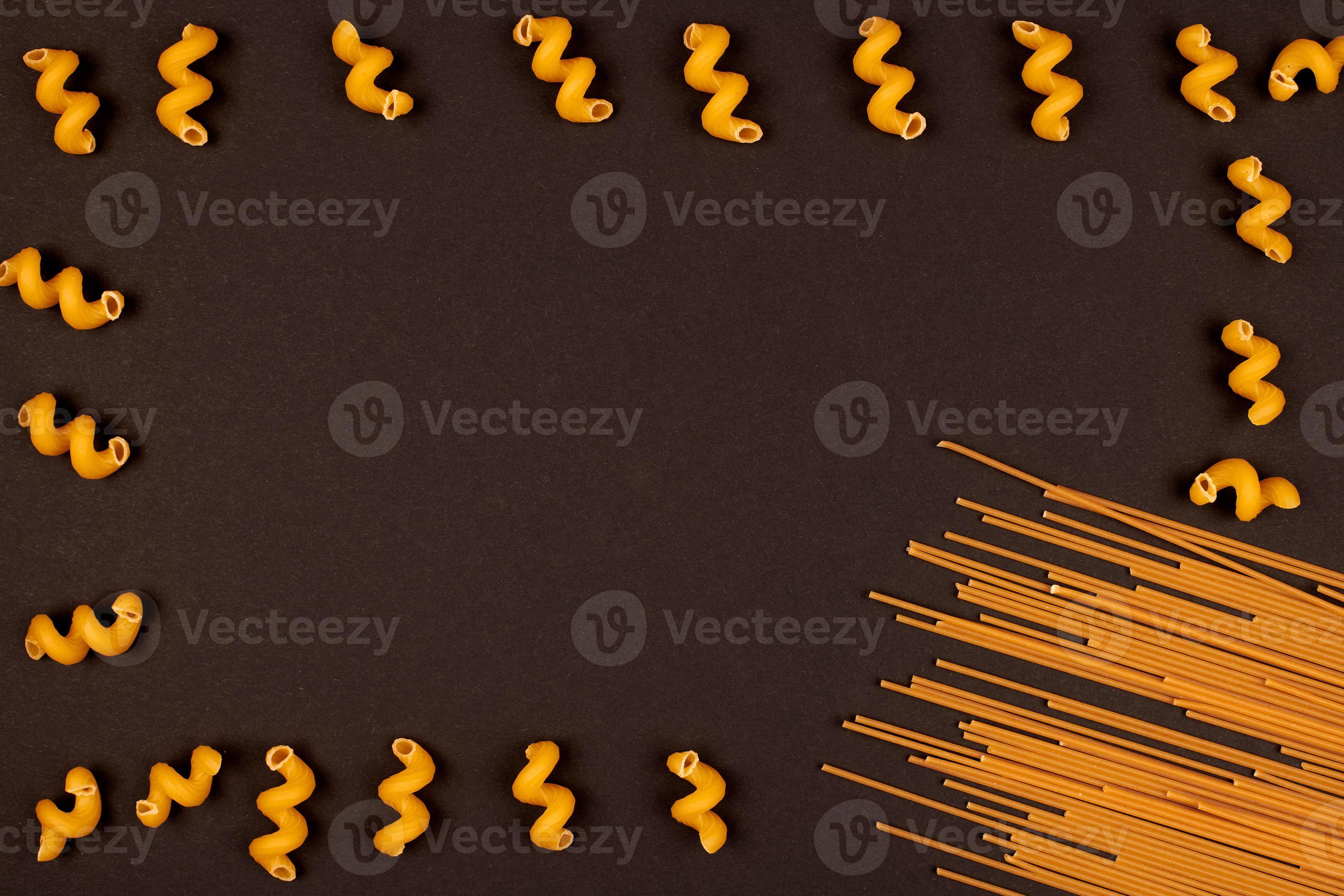 Italian pasta, black background 9755180 Stock Photo at Vecteezy