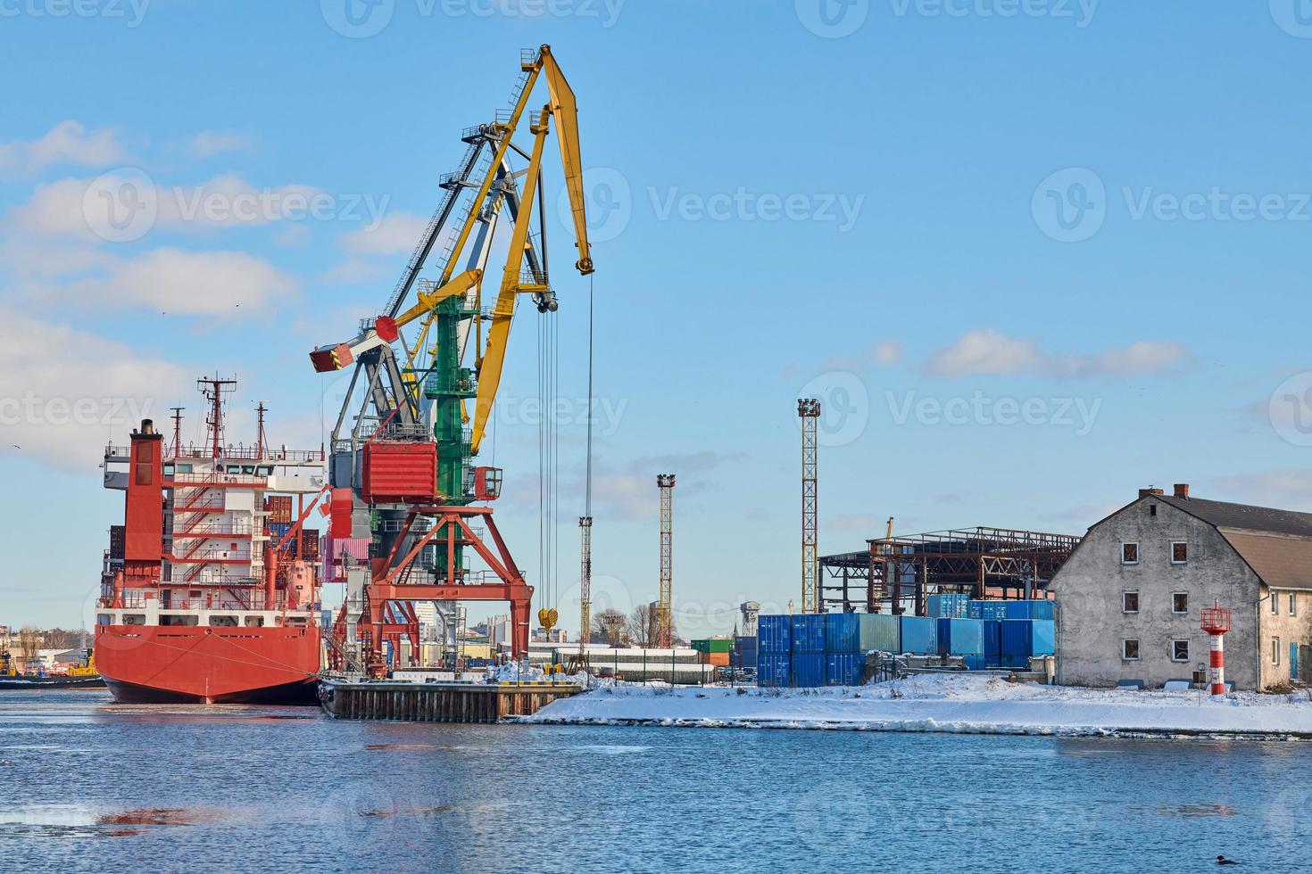 Moored ships and harbor cranes in port photo