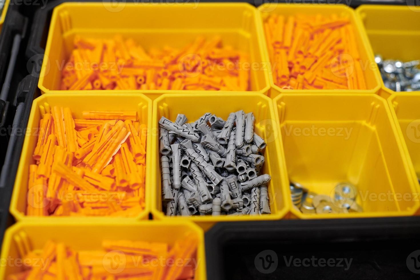 Storage case with screws, nuts, bolts, nails and other small tools for handyman, close up photo