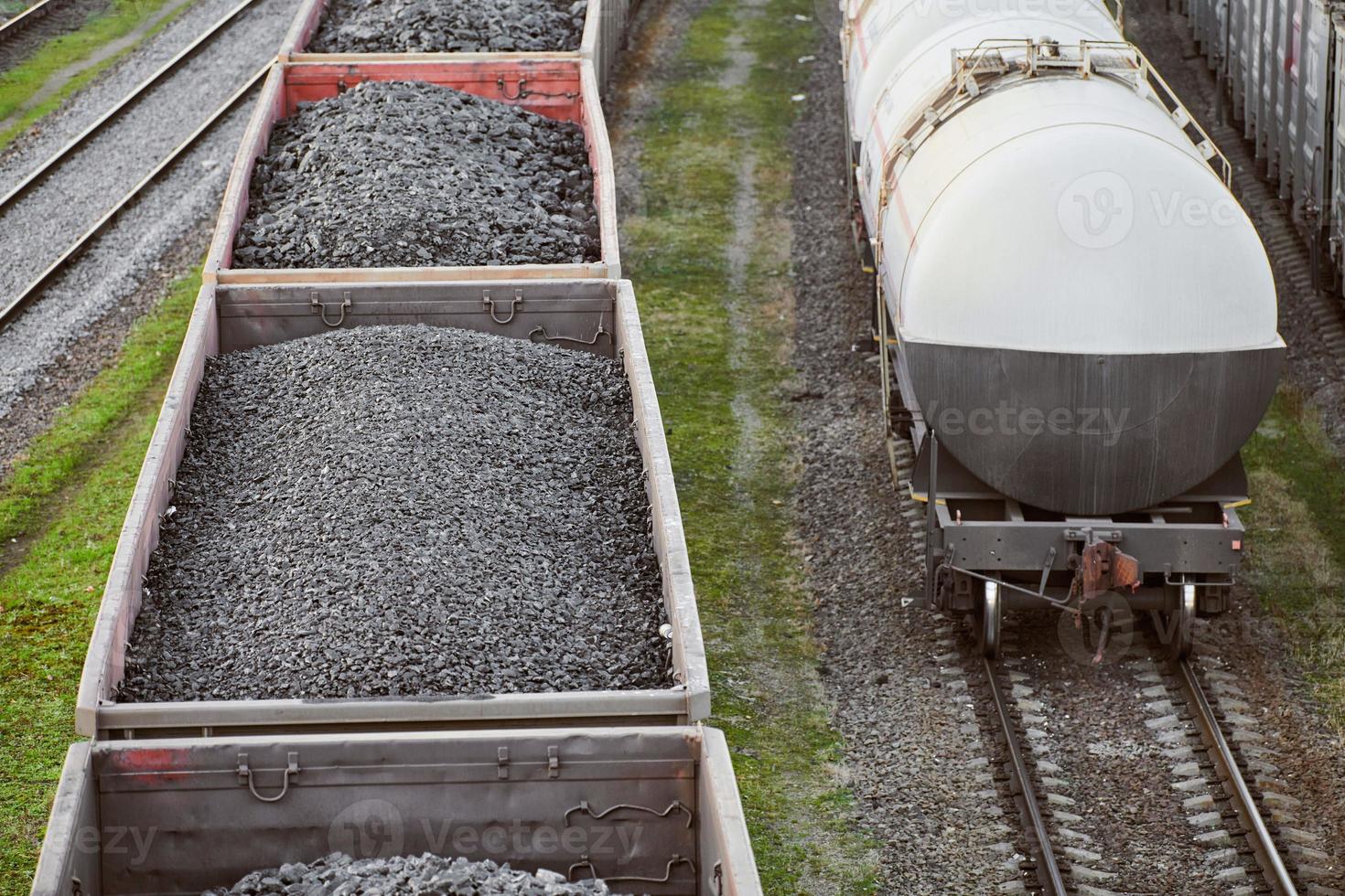 Freight train with cargo cars transporting coal, wood, fuel photo