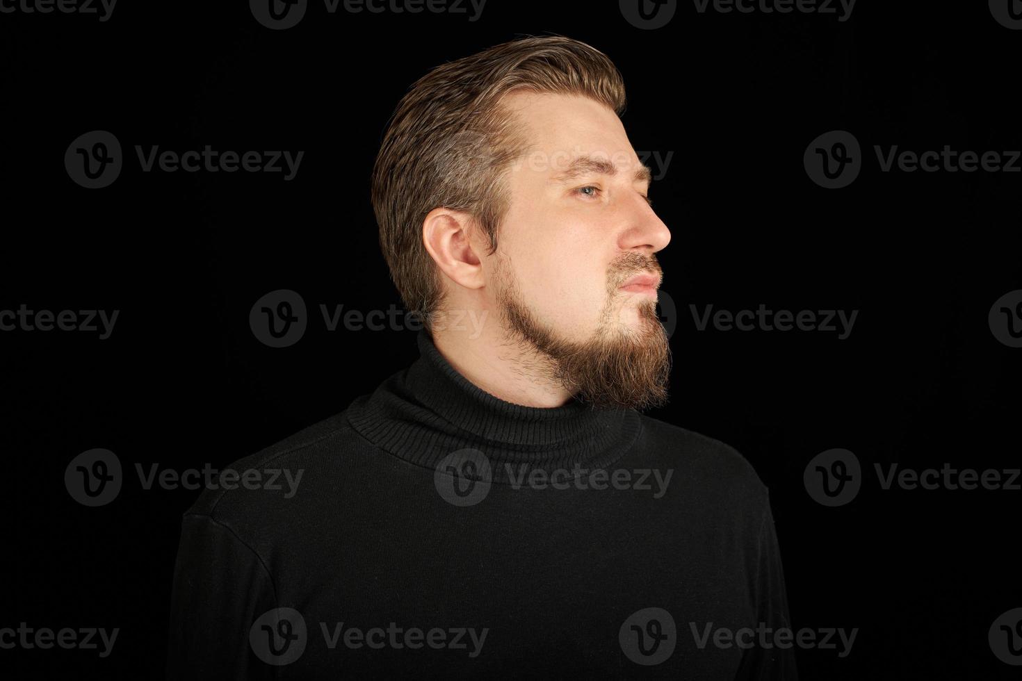 Cute bearded man, half-face portrait, black background photo