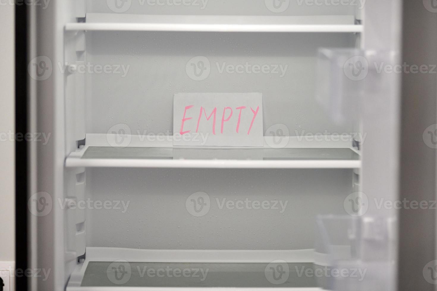 Empty refrigerator concept. Empty shelves of new refrigerator. Weight loss diet concept. photo