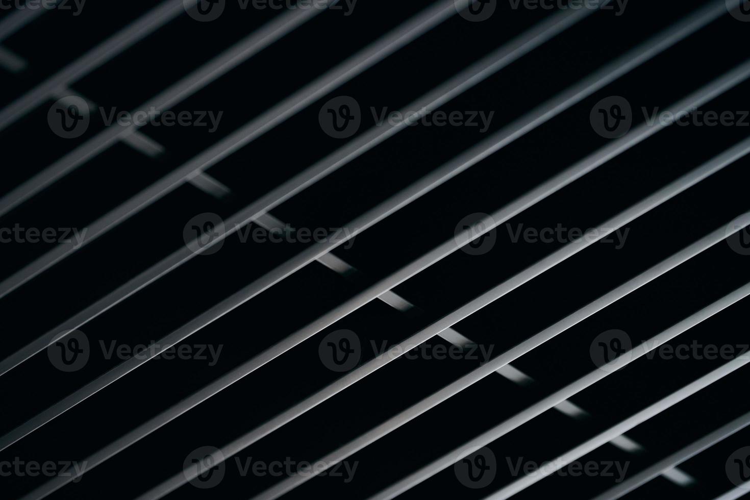 Office grille ceiling. Modern black metal grille ceiling, suspended covering. Abstract design texture. photo