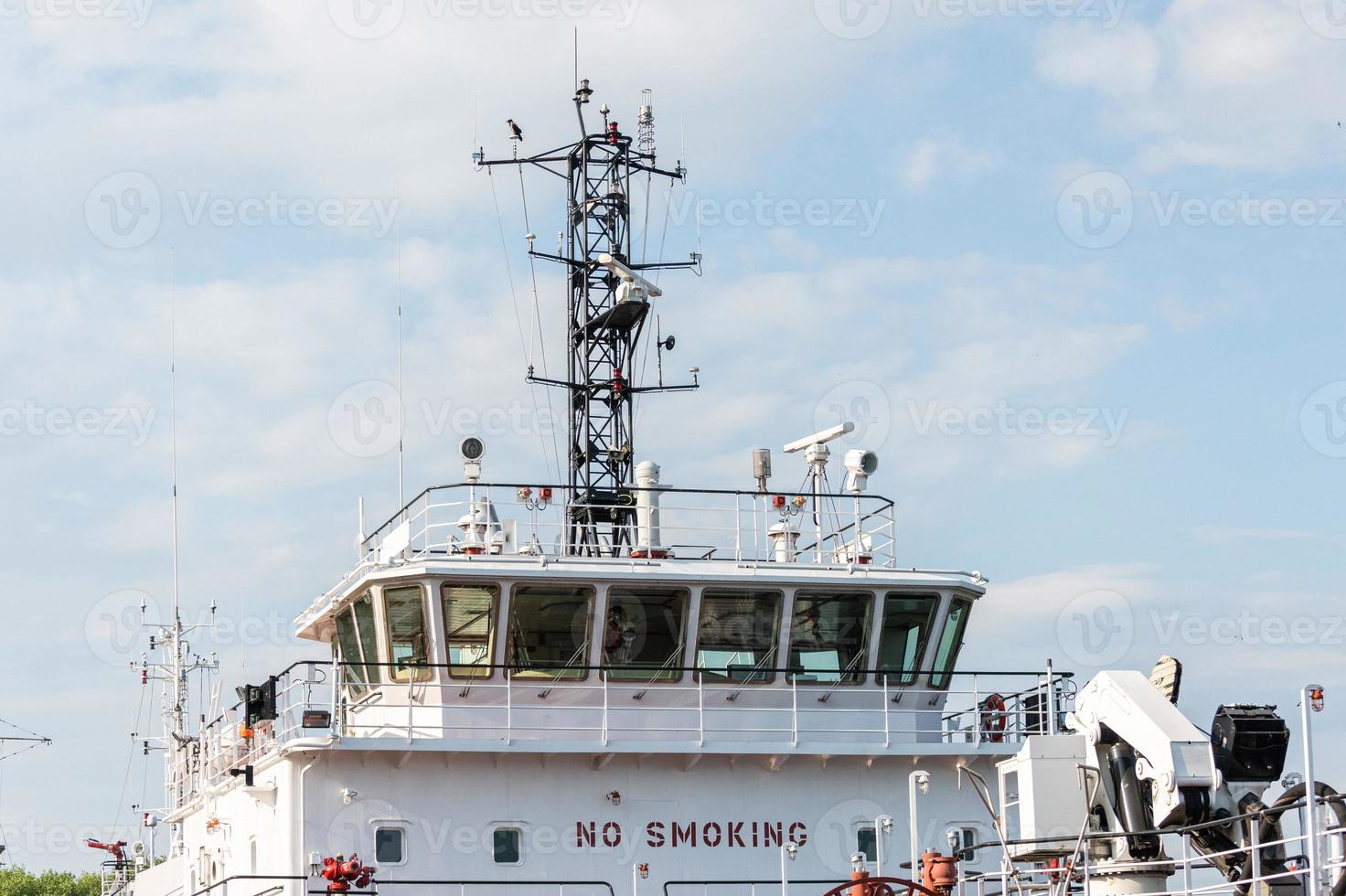 Ship bridge for navigation and control. Cargo ship waiting for a captain and crew. Vessel is ready to shove off and start new voyage. photo