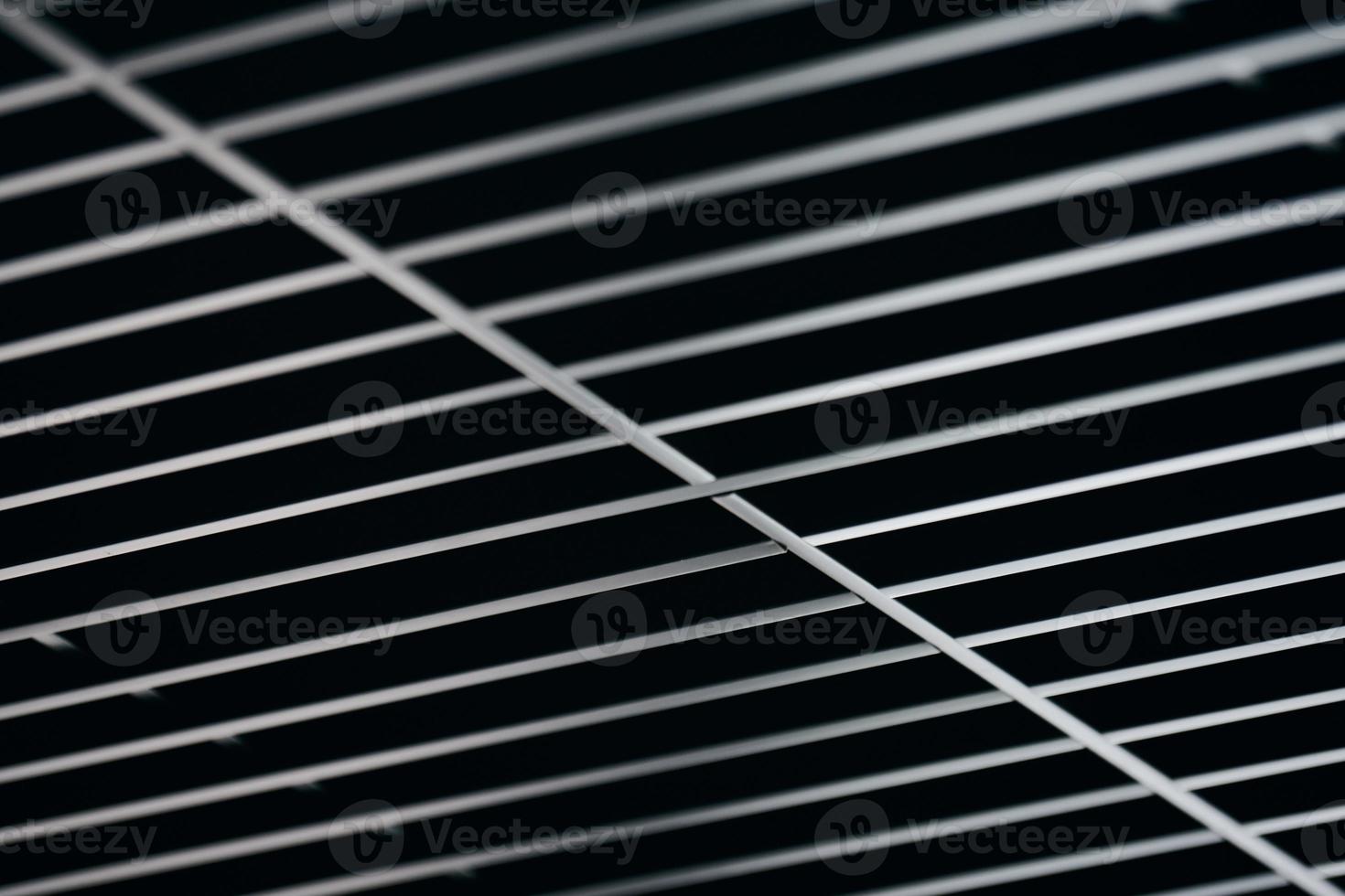 Office grille ceiling. Modern black metal grille ceiling, suspended covering. Abstract design texture. photo