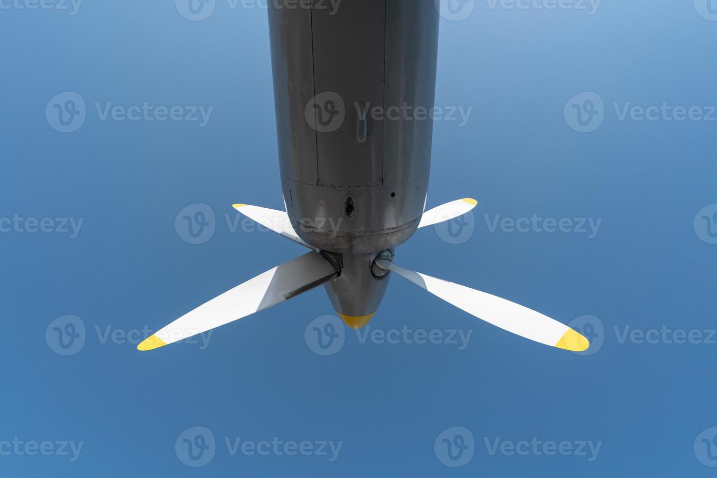 Airplane propeller of military aircraft, copy space. Blue sky sunny background. photo