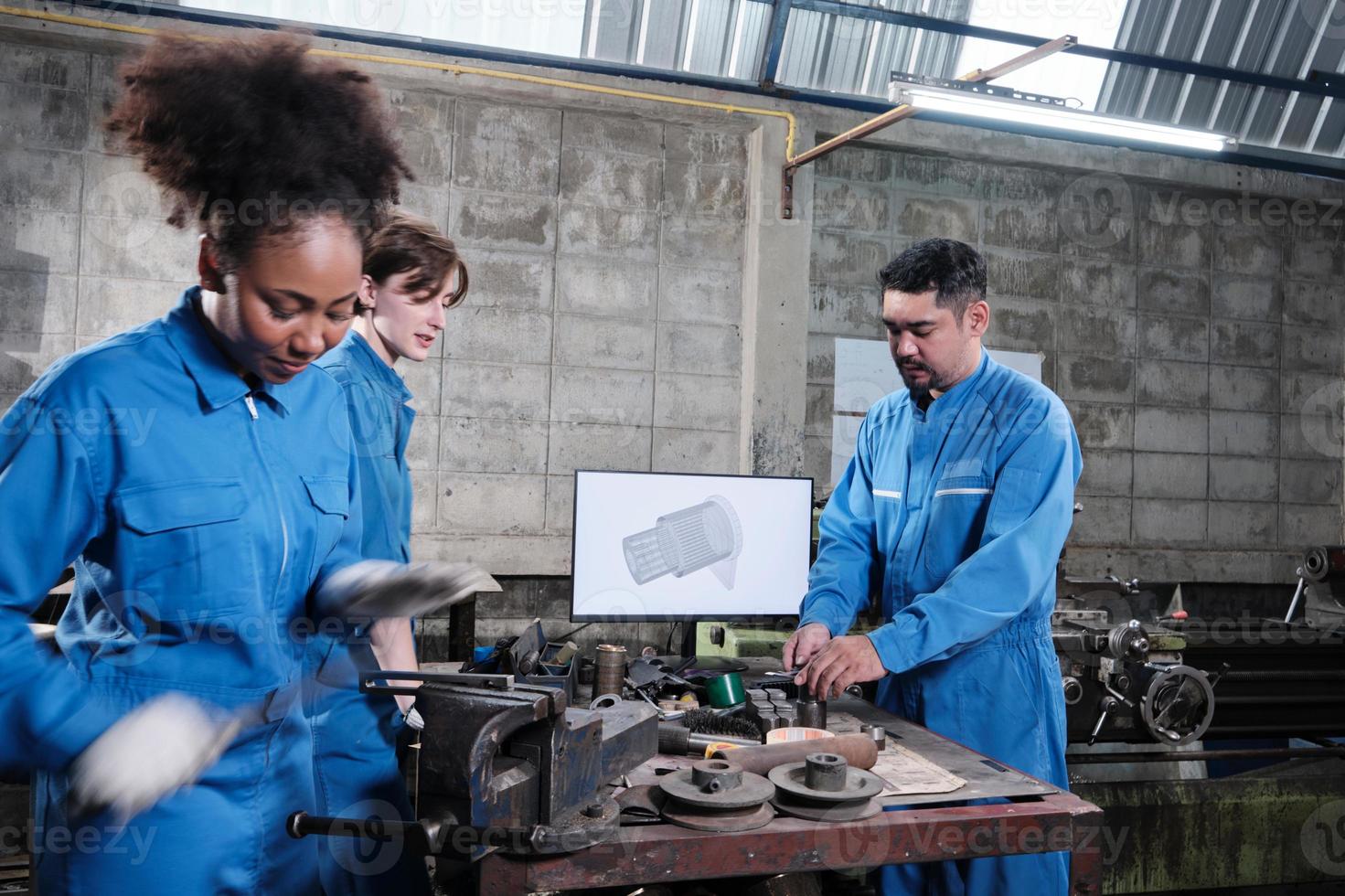 Three multiracial professional industry engineer workers teams in safety uniforms metalwork jobs discuss with mechanical drawing in a monitor, lathe machines, and workshop in manufacturing factory. photo