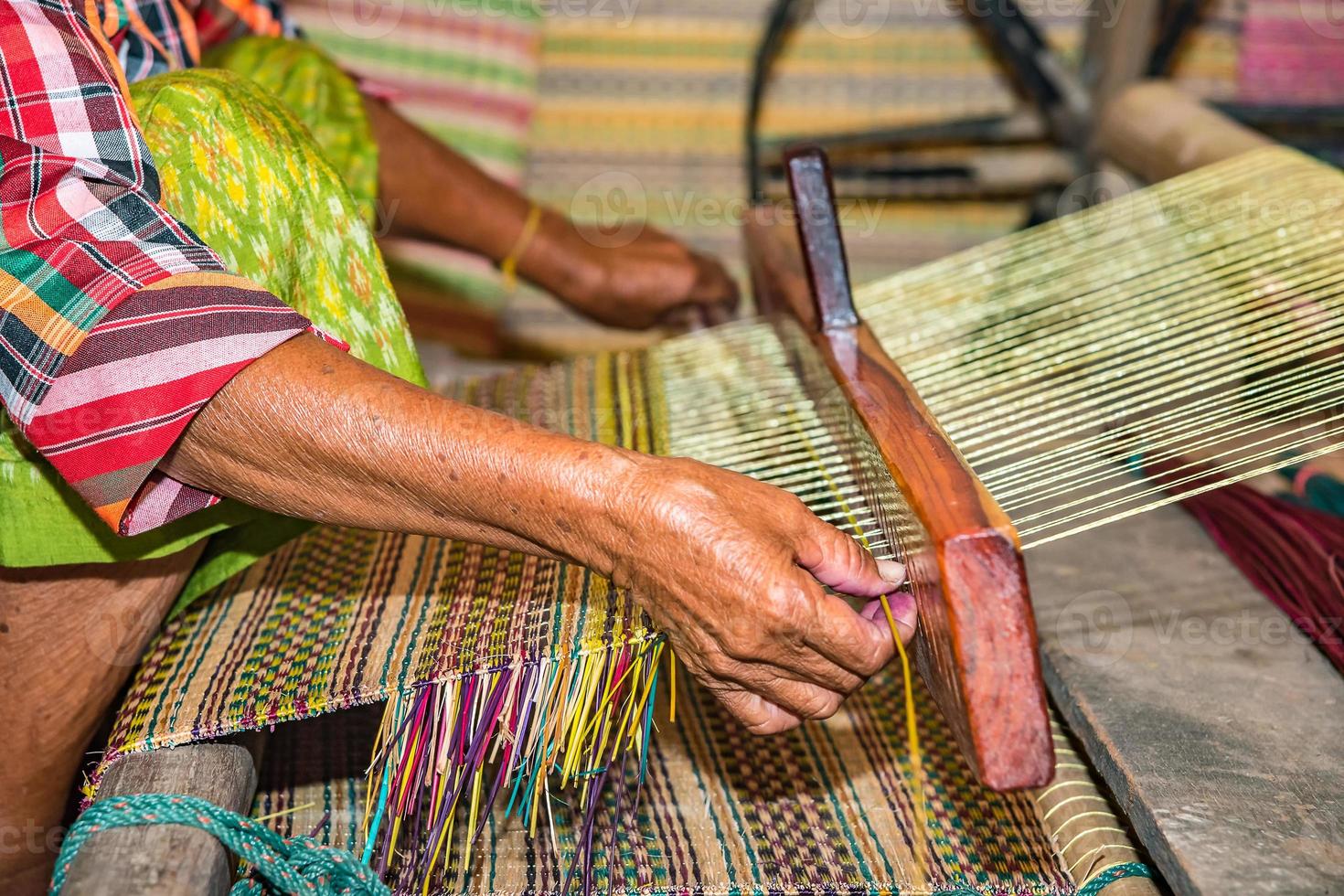 Weaving mats from dry reed 9756465 Stock Photo at Vecteezy