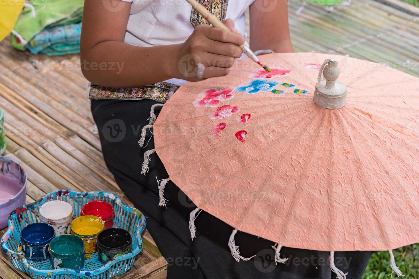 Yong girl painting on umbrella photo