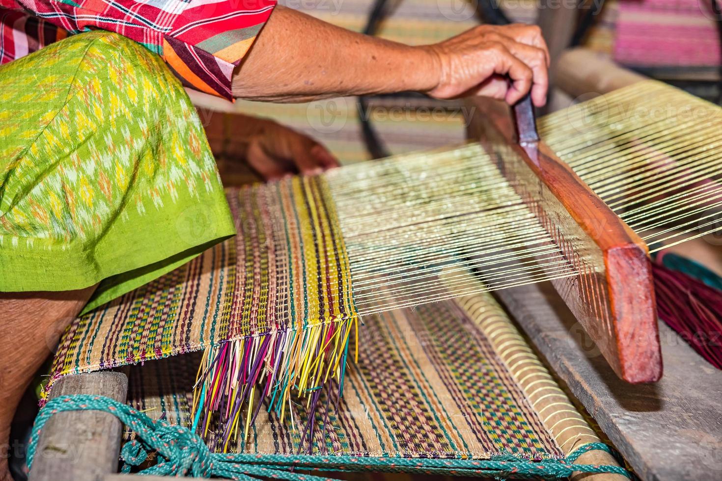 Weaving mats from dry reed 9756610 Stock Photo at Vecteezy