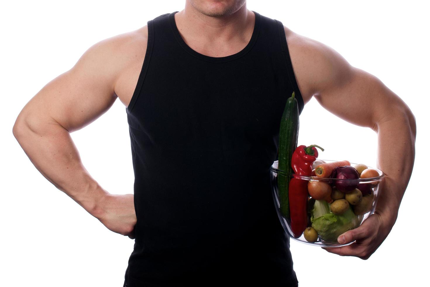 Raw food man holding vegetables and fruit photo
