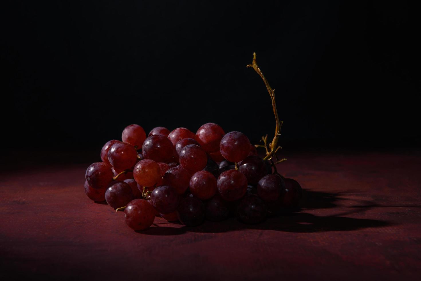 Red, ripe grapes on a rustic table photo