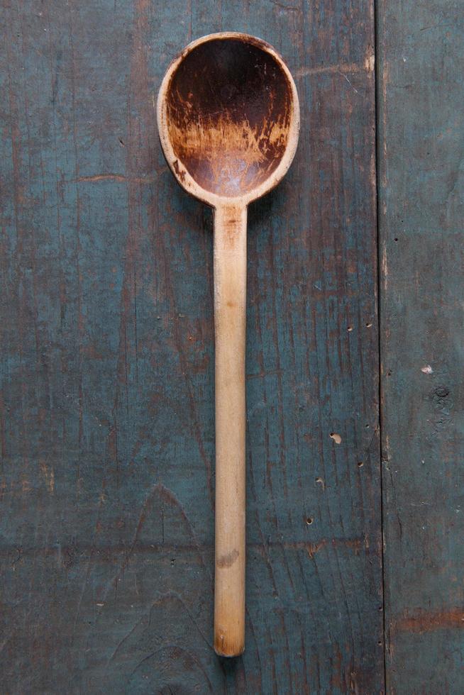 Wooden spoon on wooden background photo