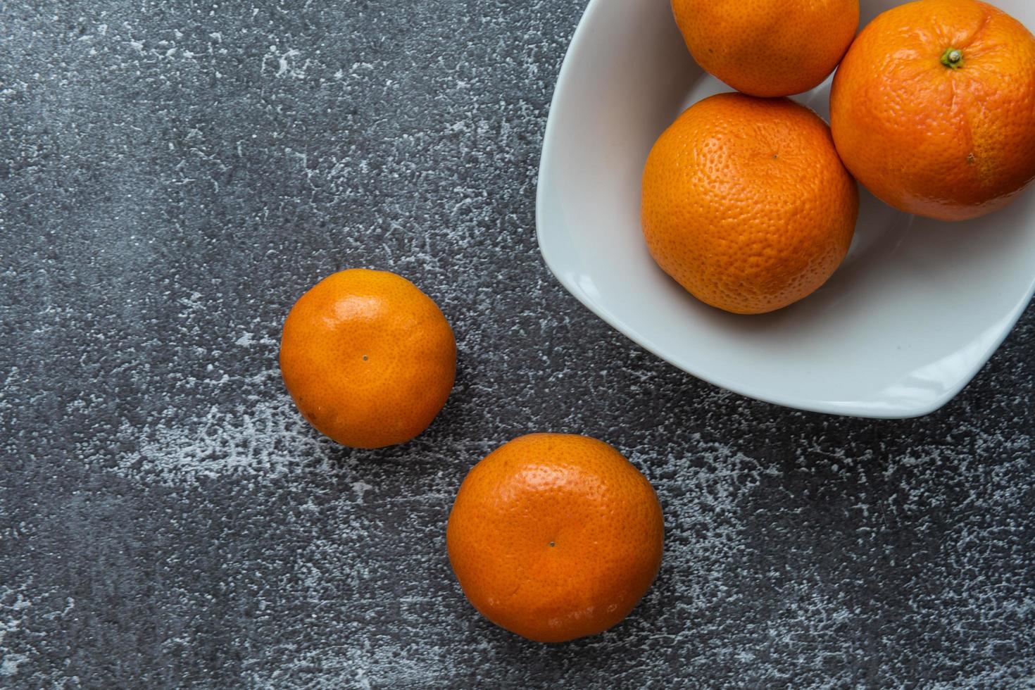Delicious clementines on rustic background photo