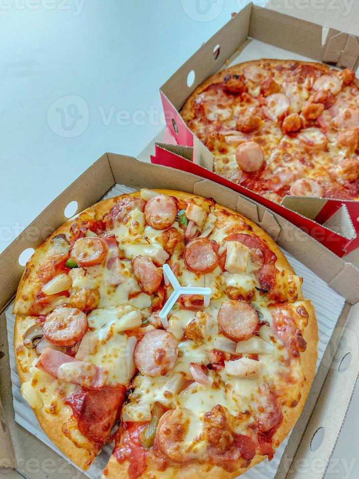 Two pans of pizza. photo