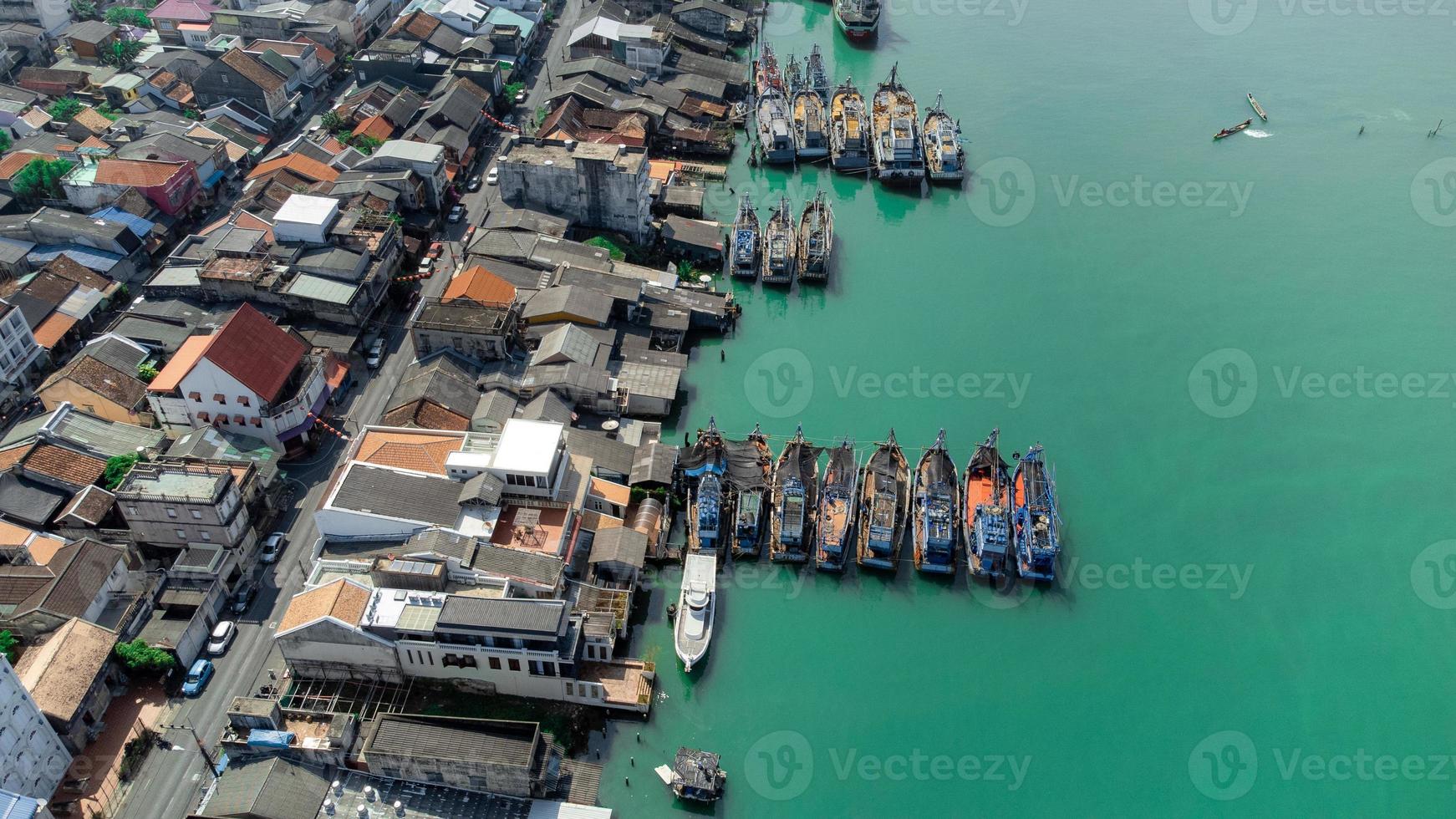 vista aérea del muelle de pescadores que tiene muchos barcos anclados para transportar mariscos y suministros en la isla de songkhla, tailandia foto