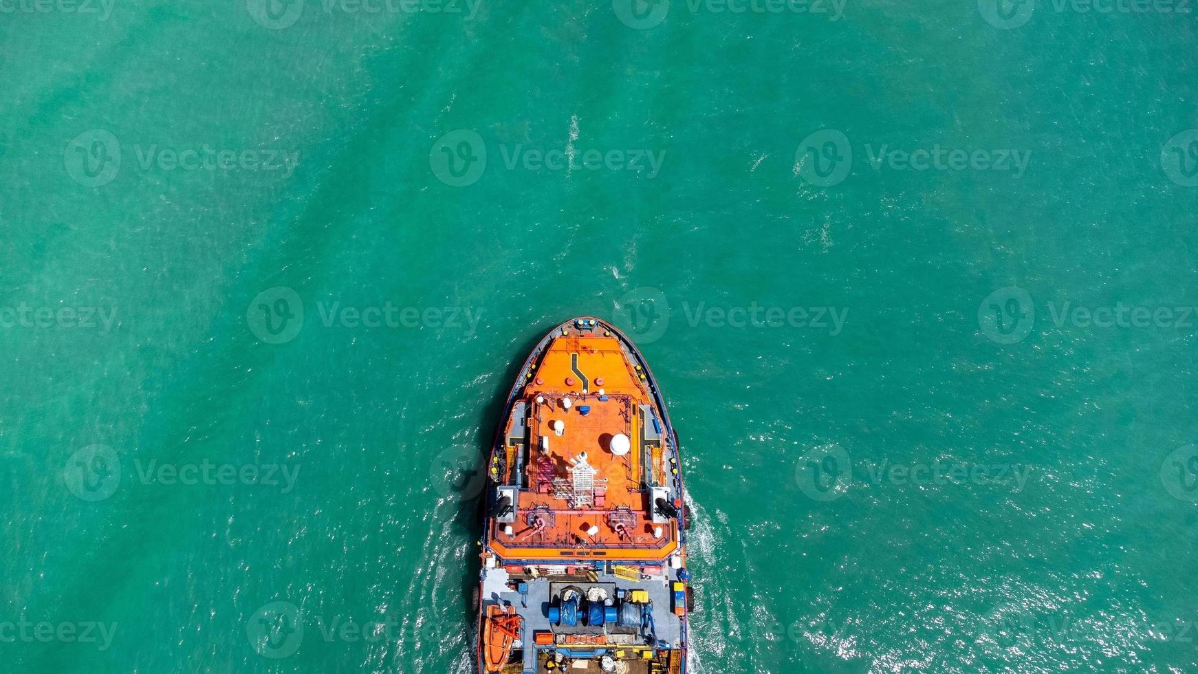 vista aérea en la parte superior del buque de carga que transporta un contenedor y se ejecuta para exportar el puerto del patio de carga al océano personalizado internacional. concepto de transporte de tecnología, despacho de aduanas, banner de seminario web. foto