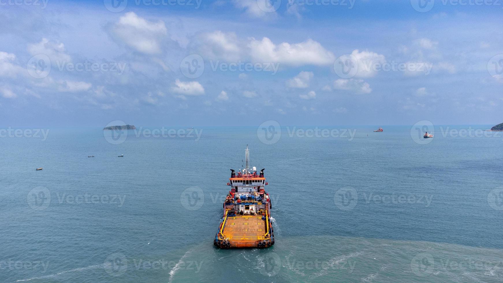 Aerial side on top view of cargo ship carrying container and running for export photo