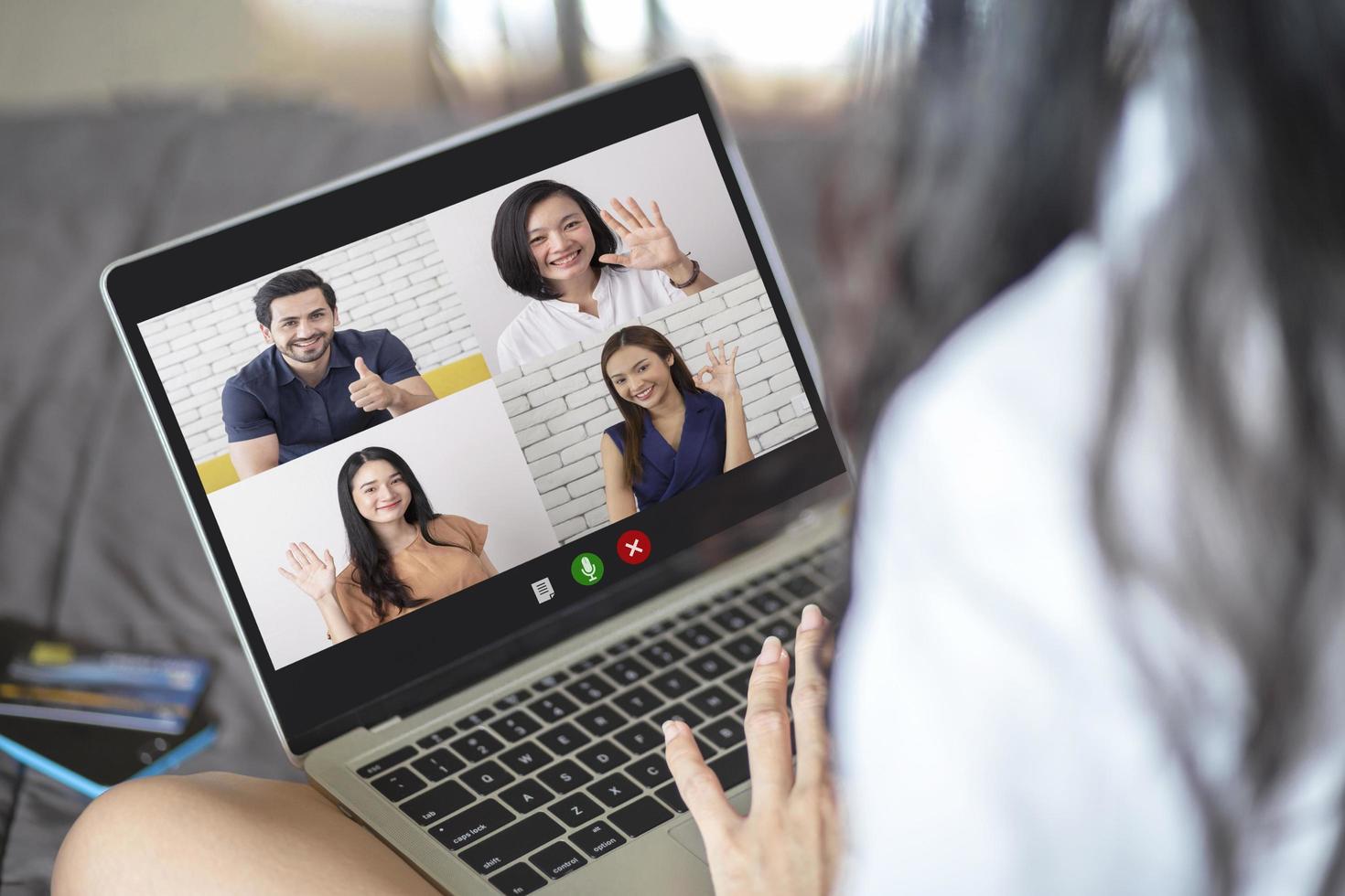 Back view of woman talking to video chat with colleagues using laptop webcam in video conference , Business team smart working online meeting in video call from home photo