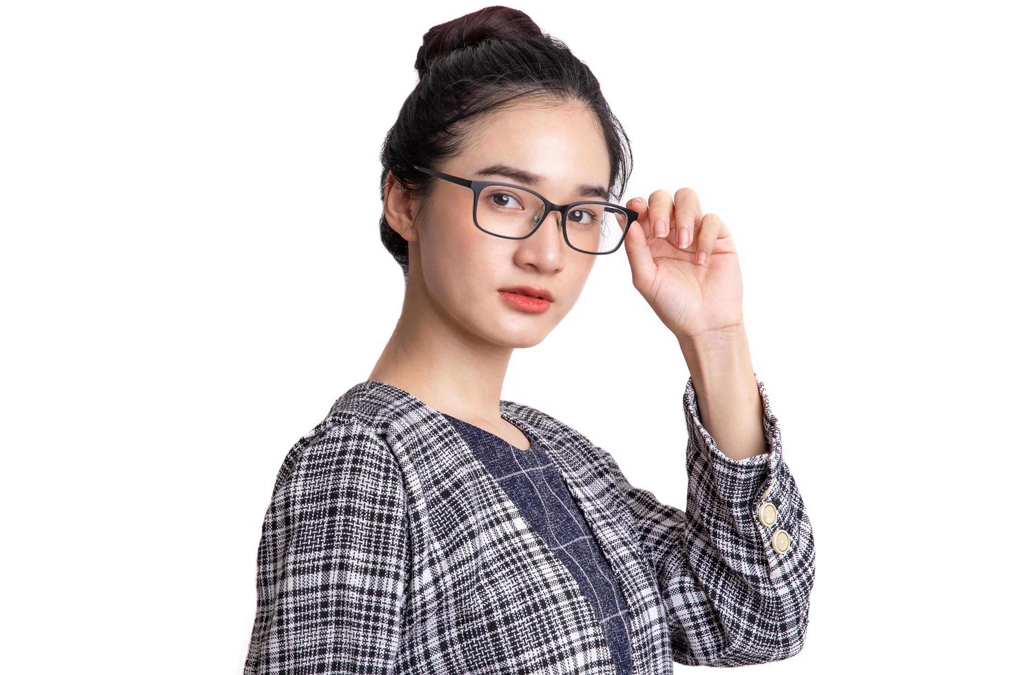 Portrait of beautiful young woman standing thinking of serious confident with spectacles isolated on white background photo