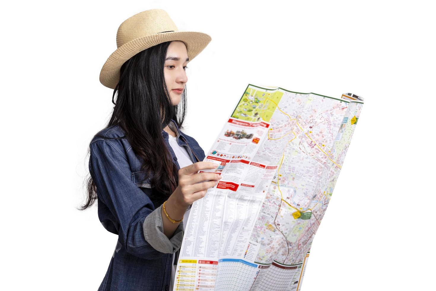 Beautiful young asian woman traveler with map on white background photo