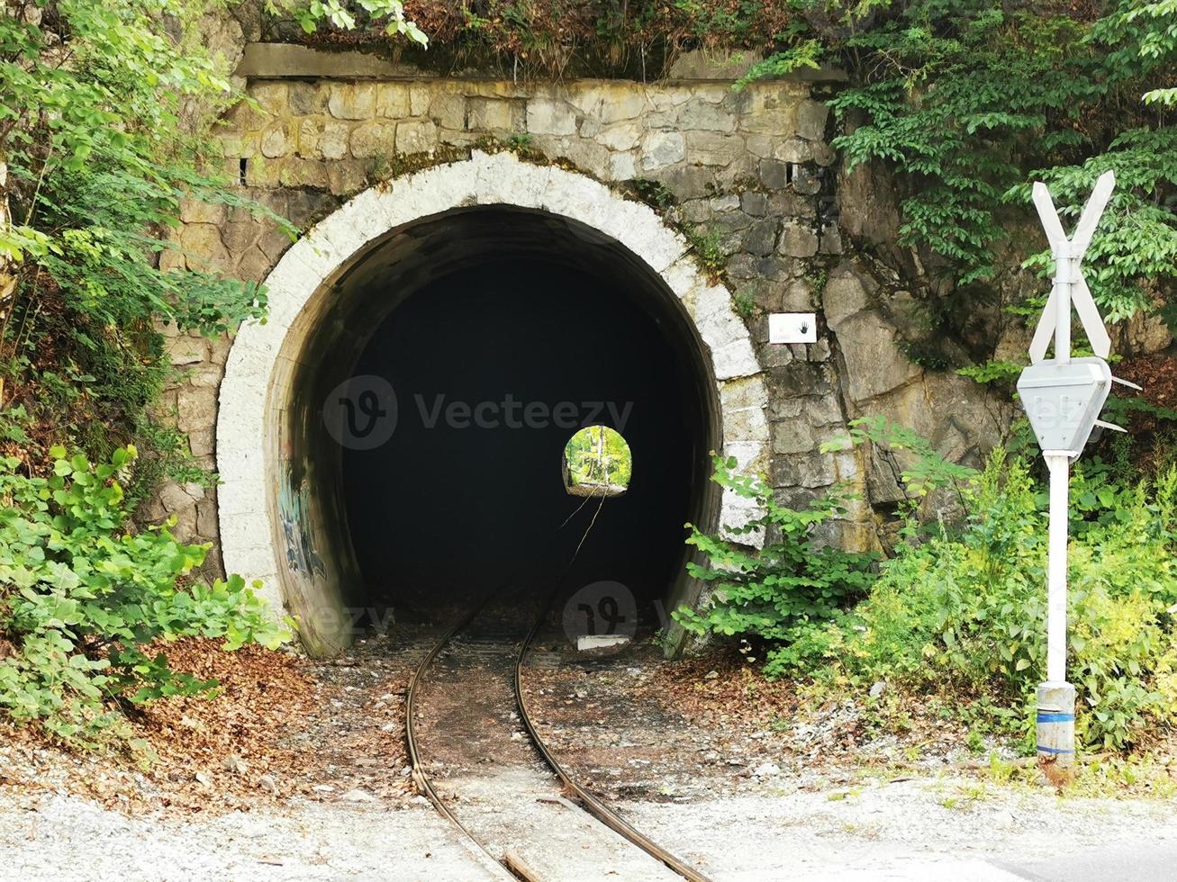 A tunnel in front of a brick wall photo
