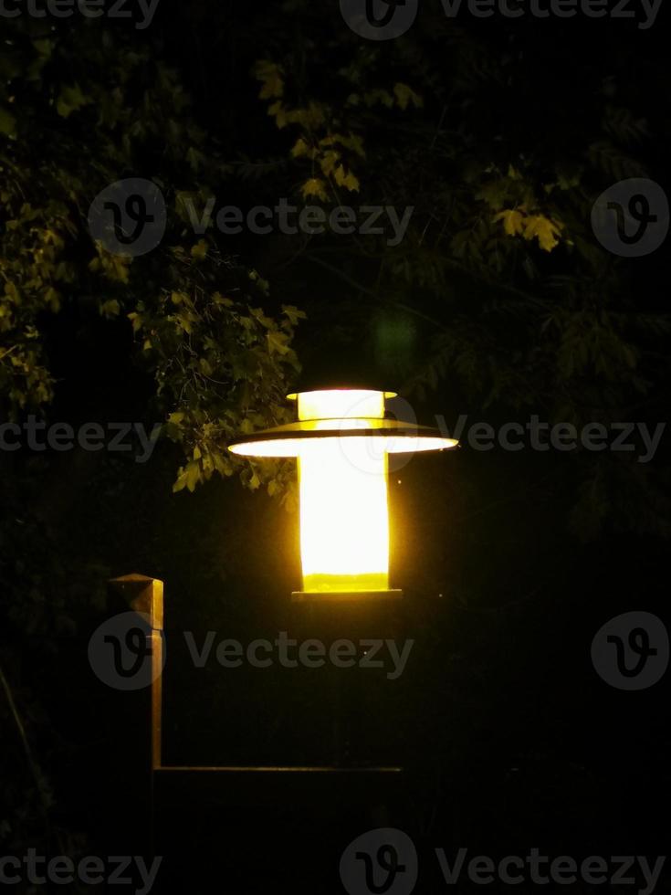 A sign lit up at night photo