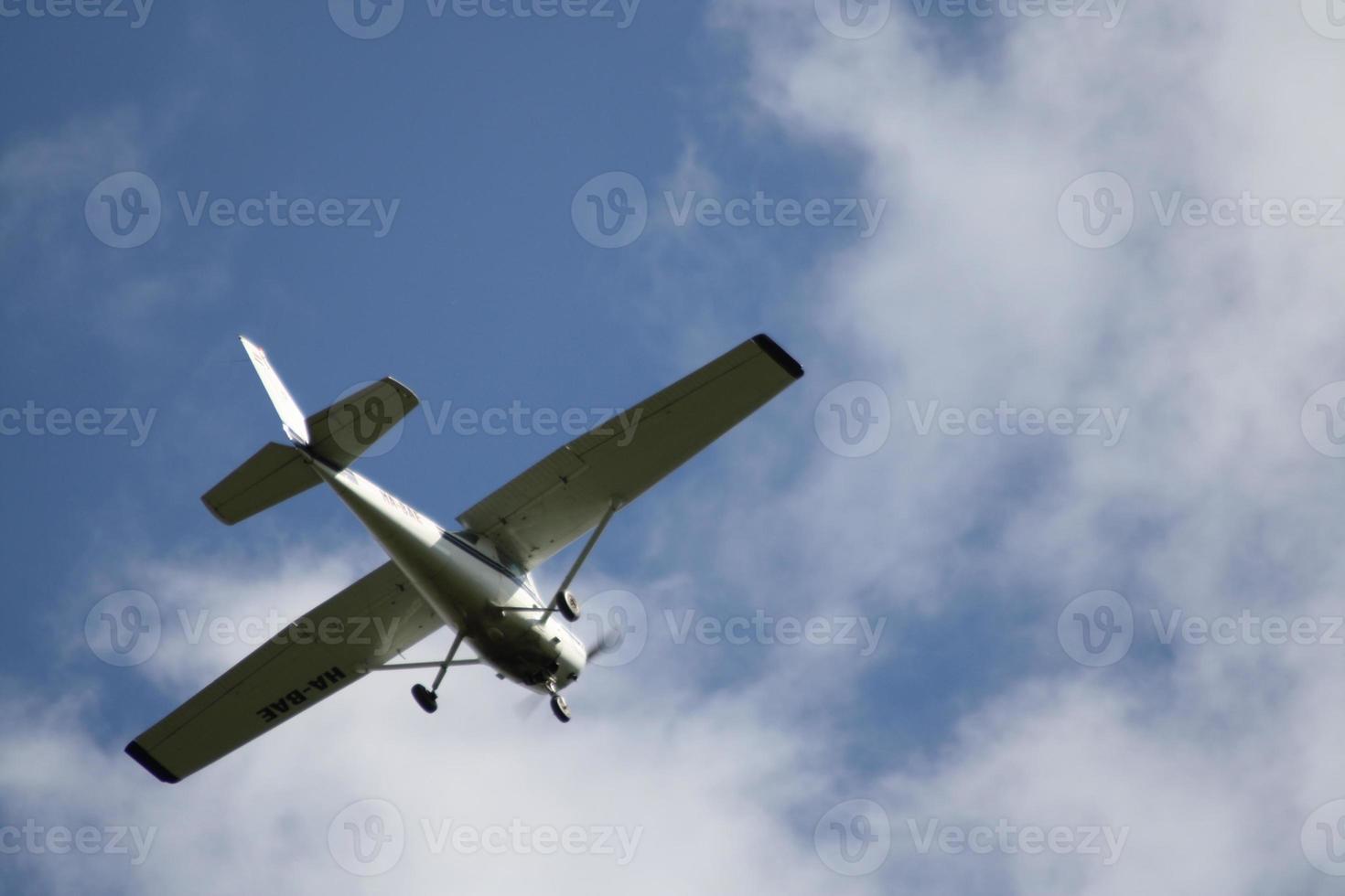 A fighter jet flying through a cloudy blue sky photo