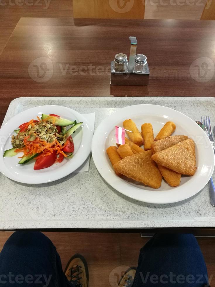 Fried cheese with croquettes and mixed salad photo