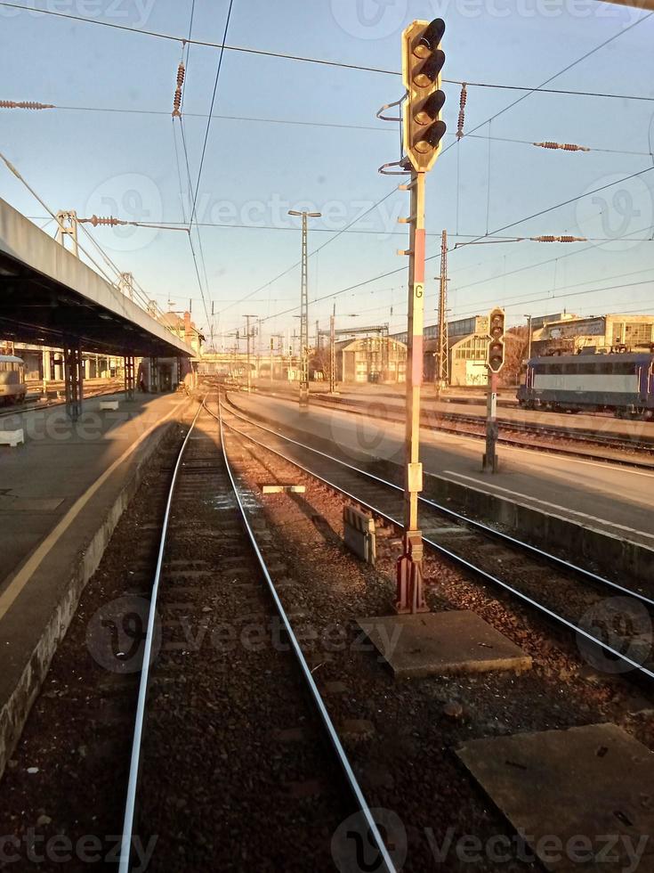 A train traveling down train tracks near a station photo