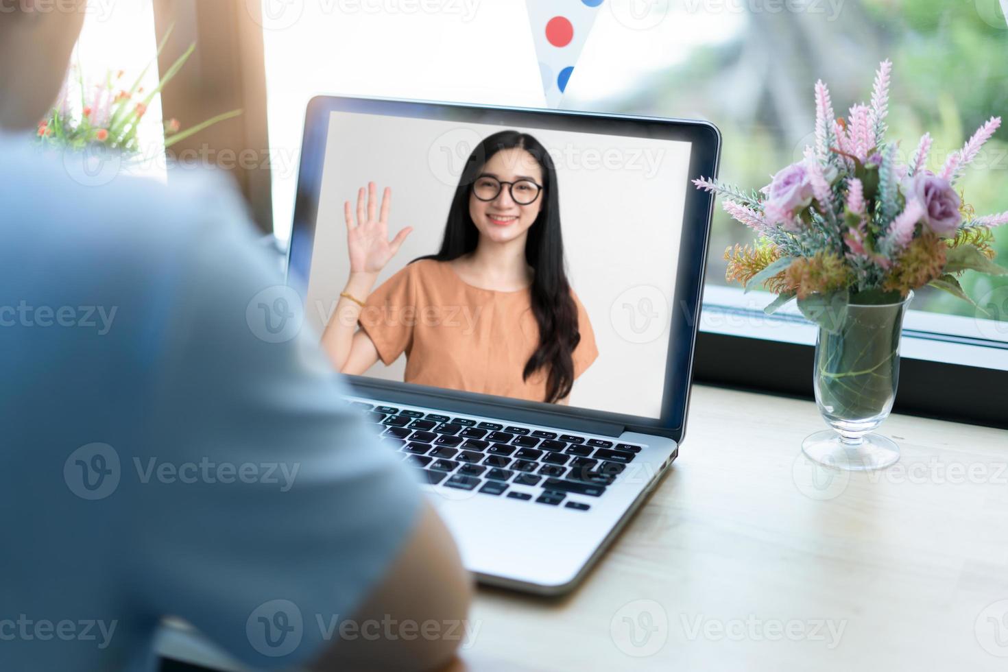 Couple using laptop for video chatting.  Remote communication concept photo