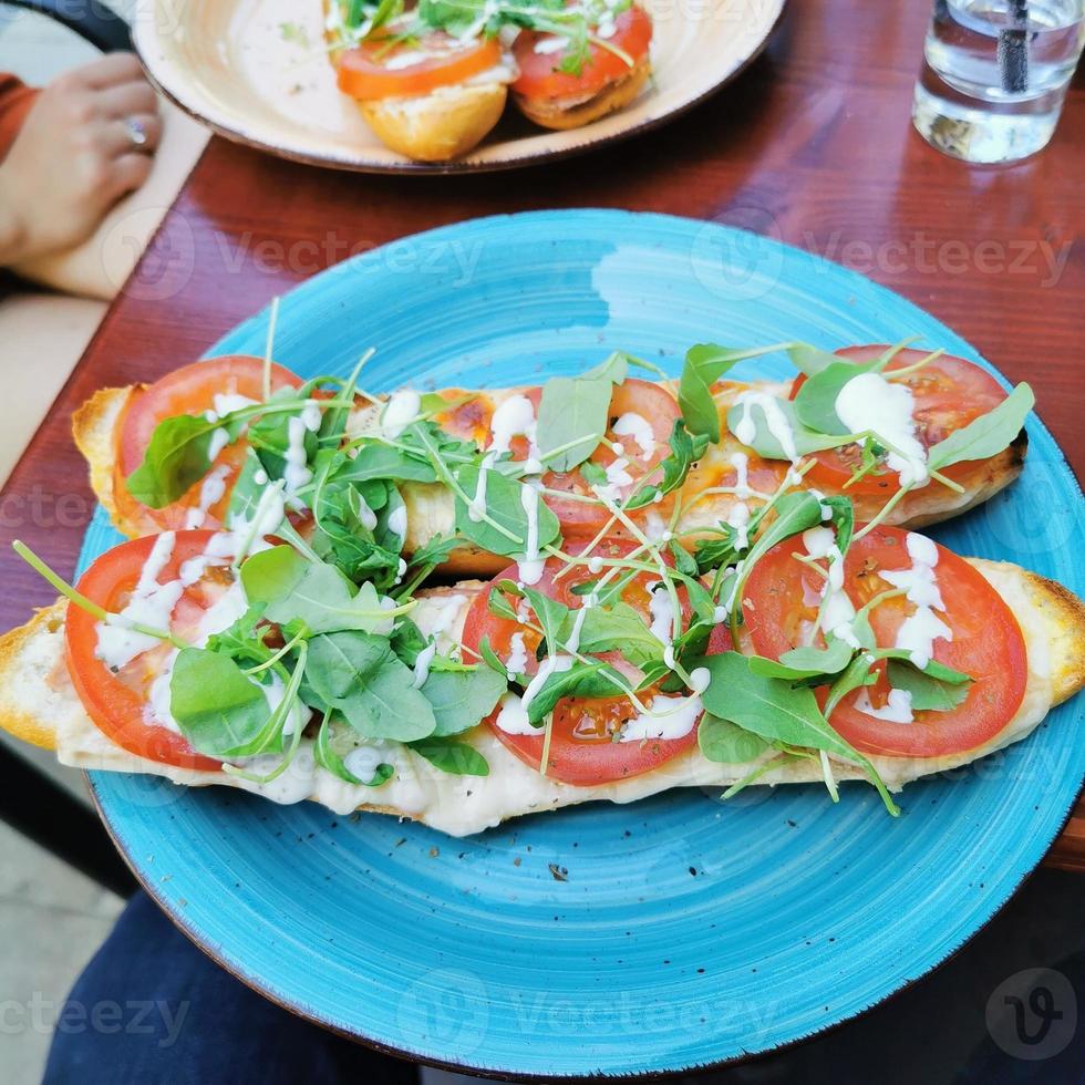 Very tasty cheese with ham and baguette tomato photo