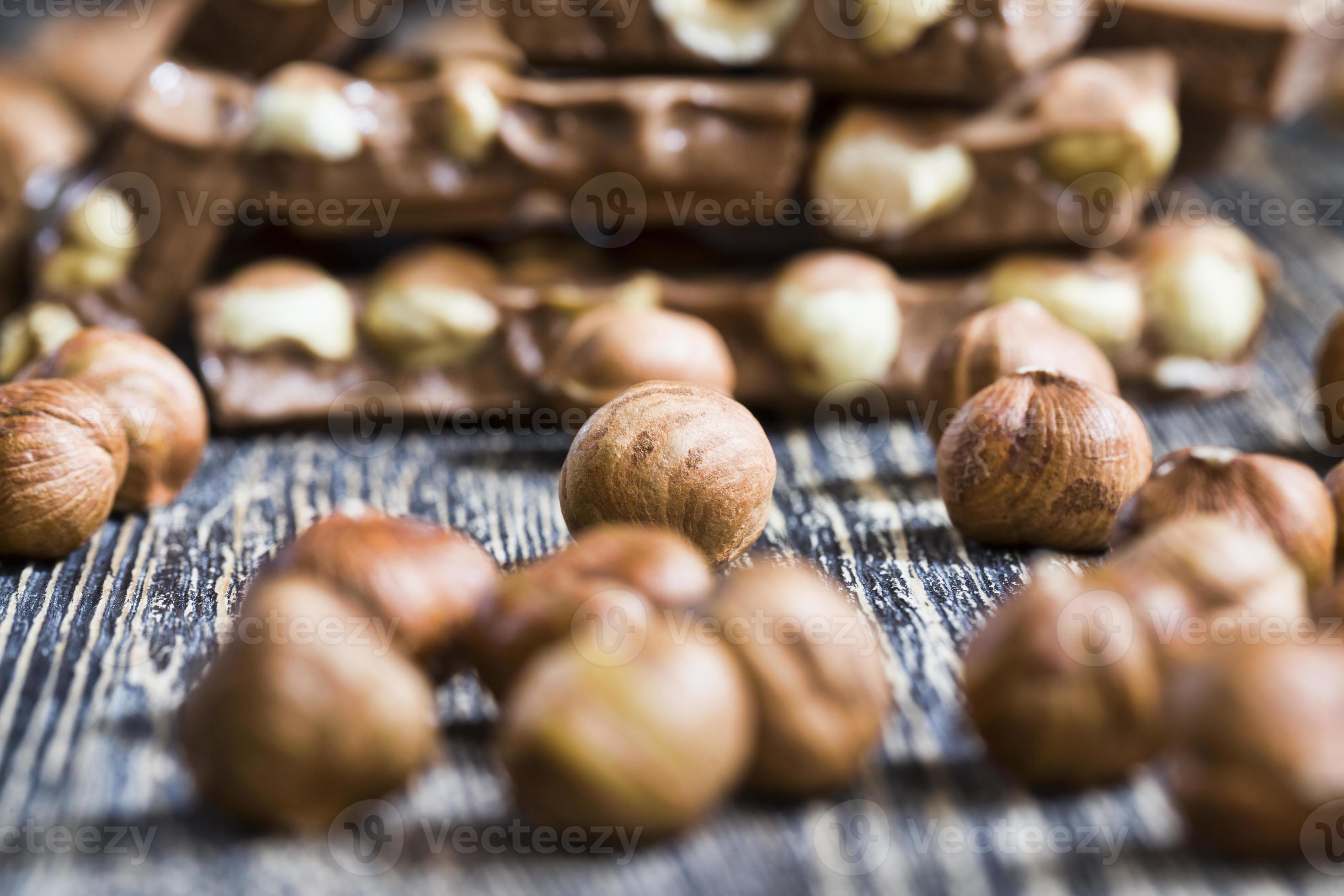 bitter real chocolate, photographed close up with whole hazelnuts