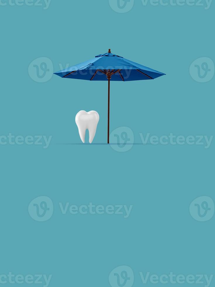 Tooth under an beach umbrella on a blue background. Dentist concept. Dentistry ads. Dental Health Concept. photo