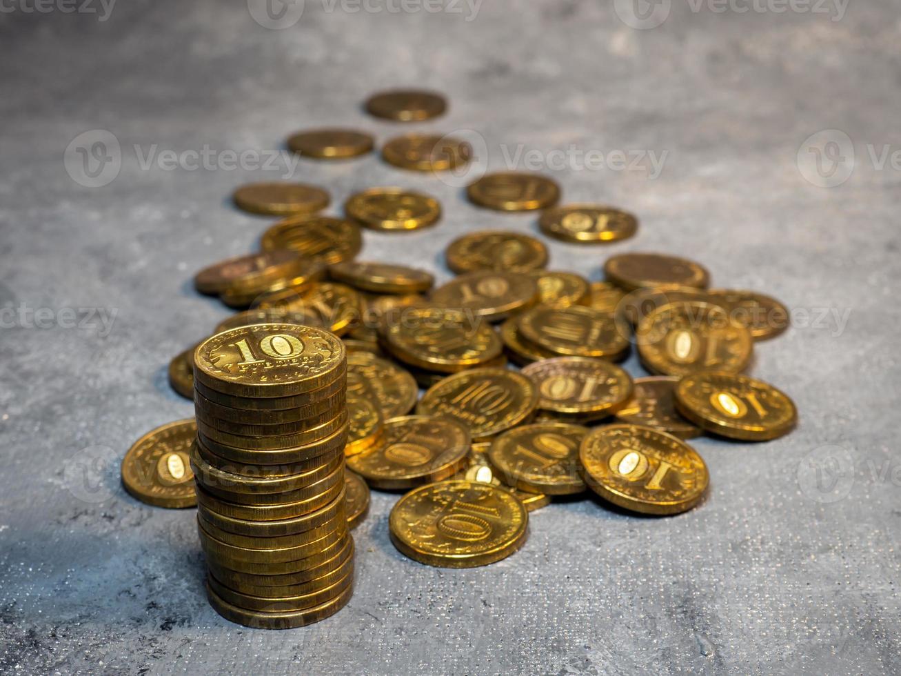 Pyramid of coins on a gray background.  Much money photo