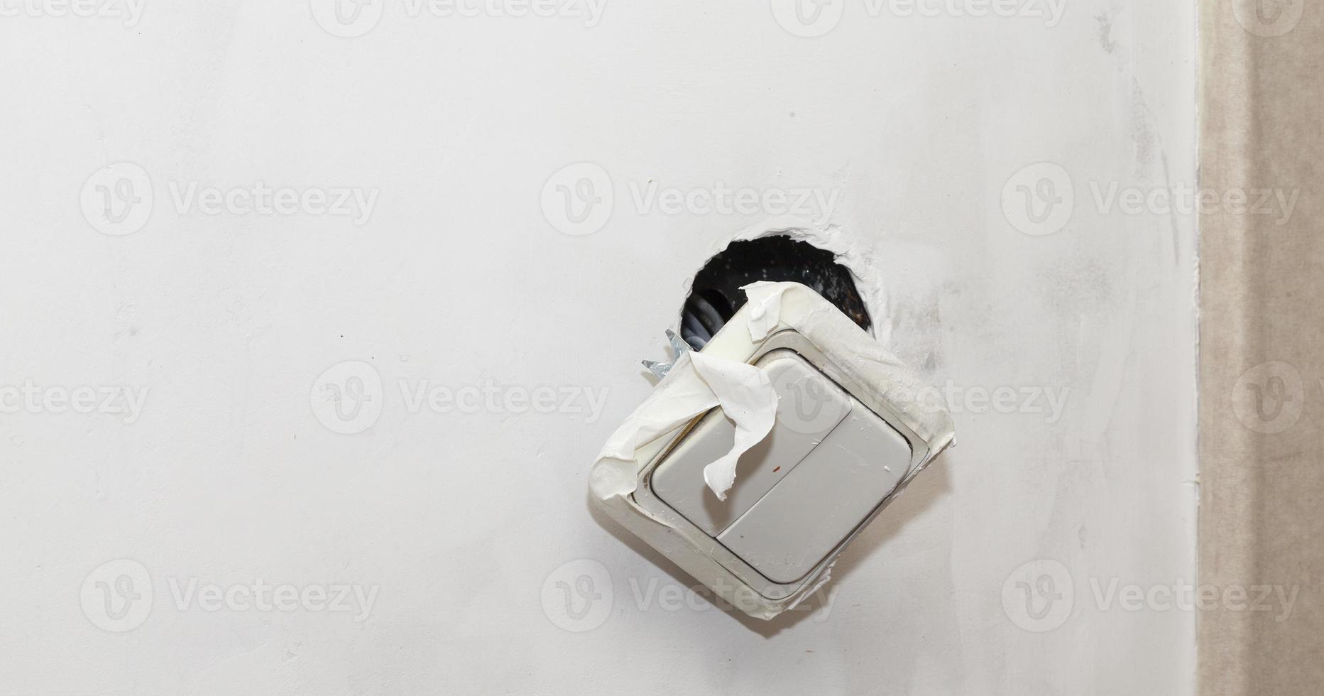 torn white light switch photo