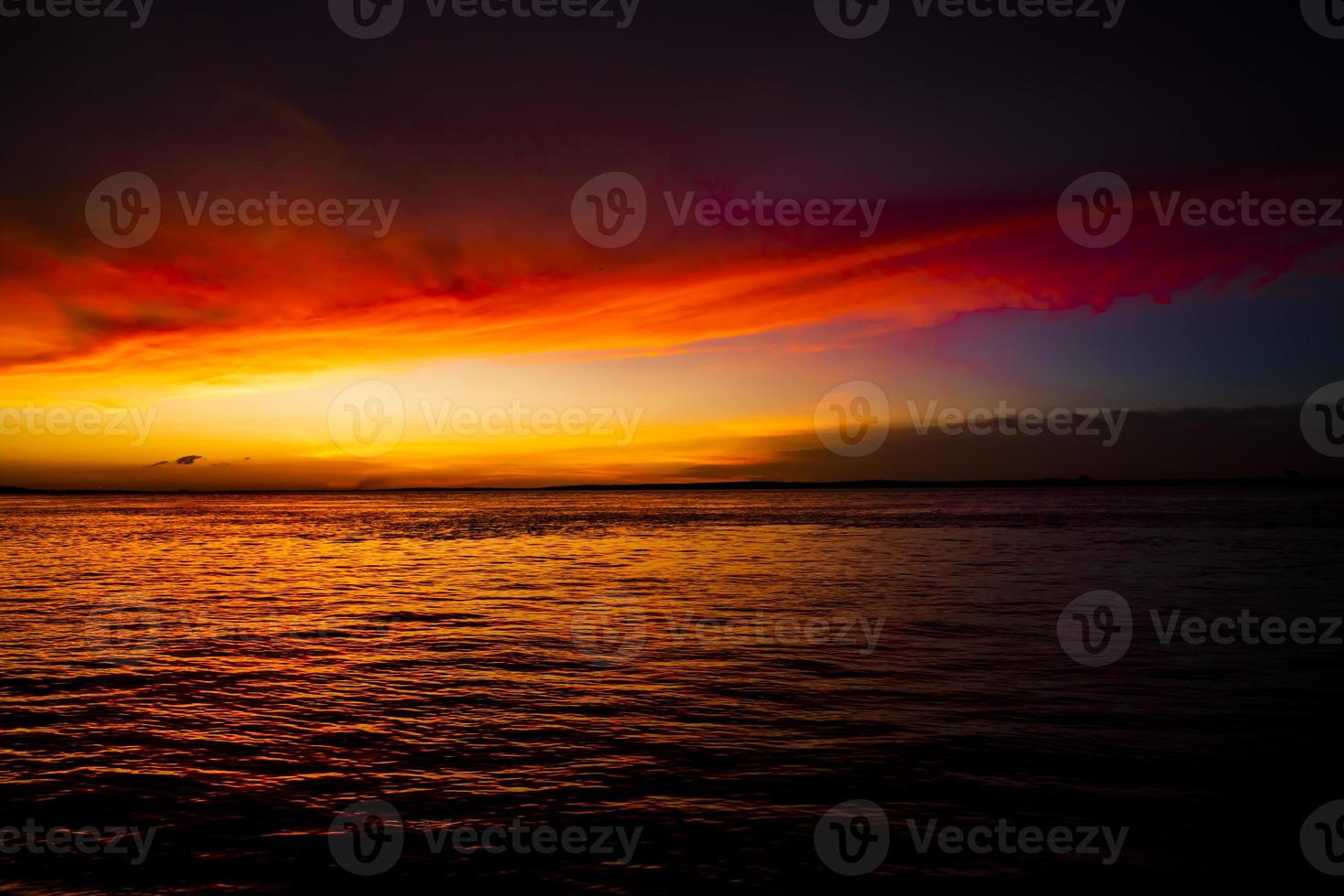 Beautiful  Scenic View Of Sea Against Orange Sky photo