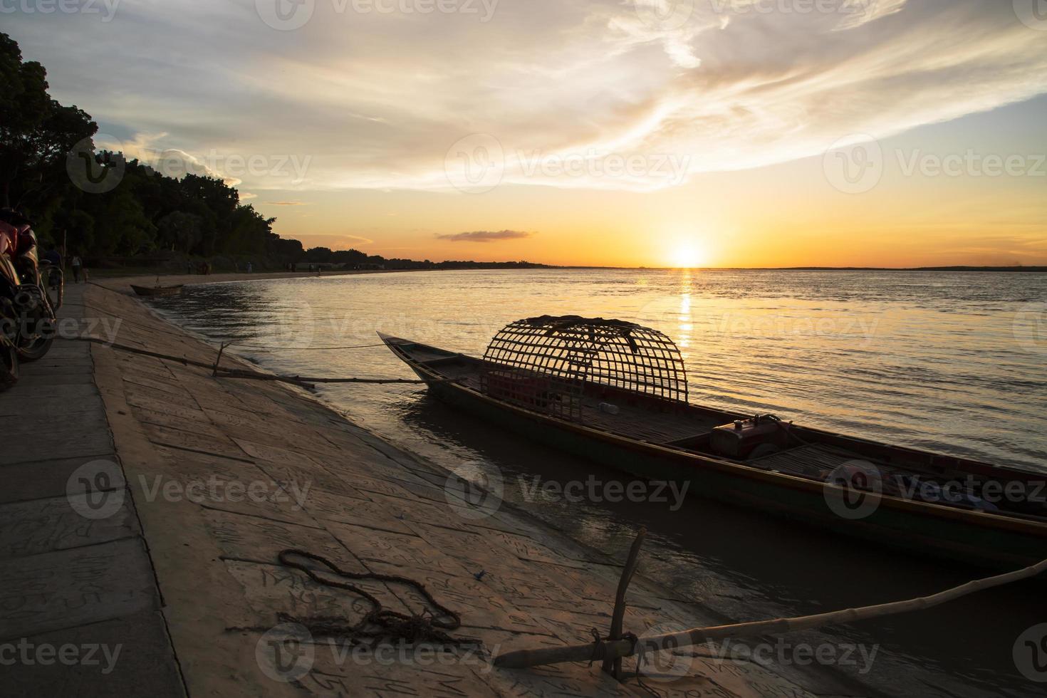 A wooden boat On Sea Against  Sky During Sunset photo