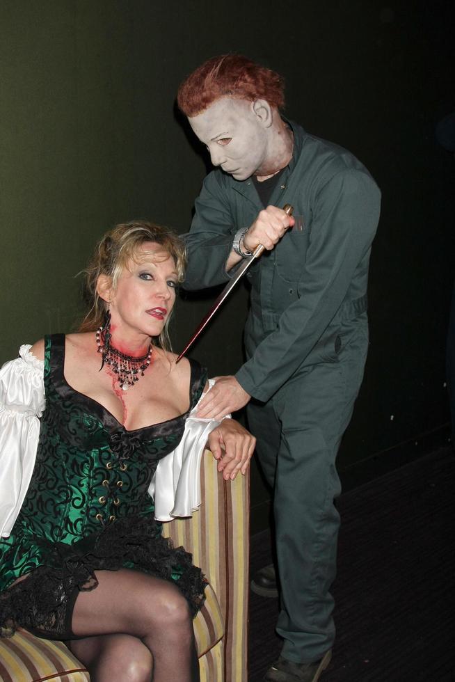 LOS ANGELES, OCT 30 - Donna Keegan and Michael Myers Costumed Guest at the sCare Foundation Halloween Launch Benefit at Conga Room, LA Live on October 30, 2011 in Los Angeles, CA photo