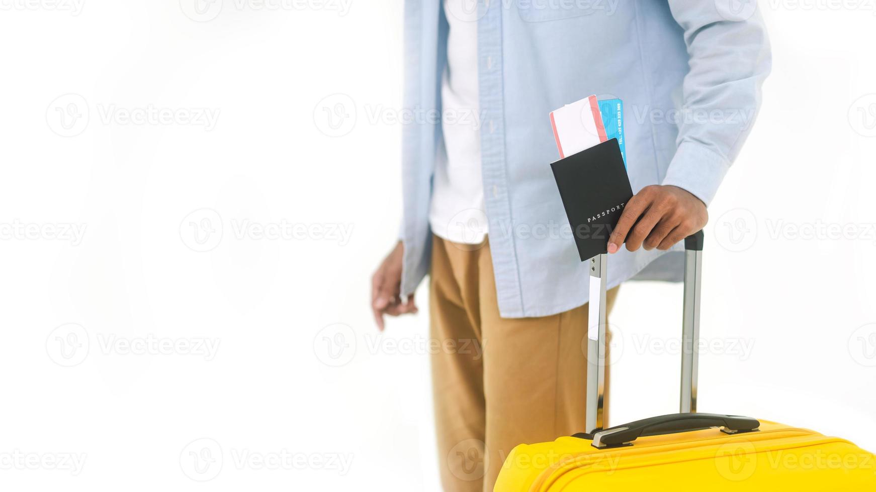 Asian man arm holding travel luggage handle passport and airplane ticket photo