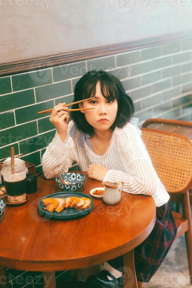 Portrait of young adult asian woman with 80s style japanese fashion in retro chinese cafe photo