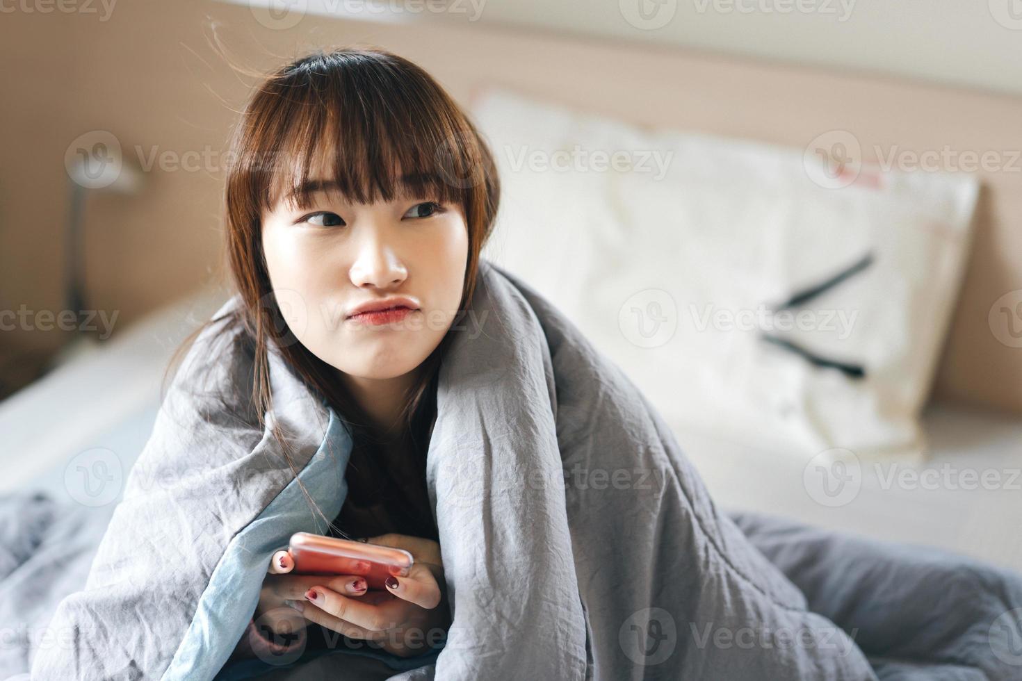 Portrait of young asian teenager woman in bedroom. photo