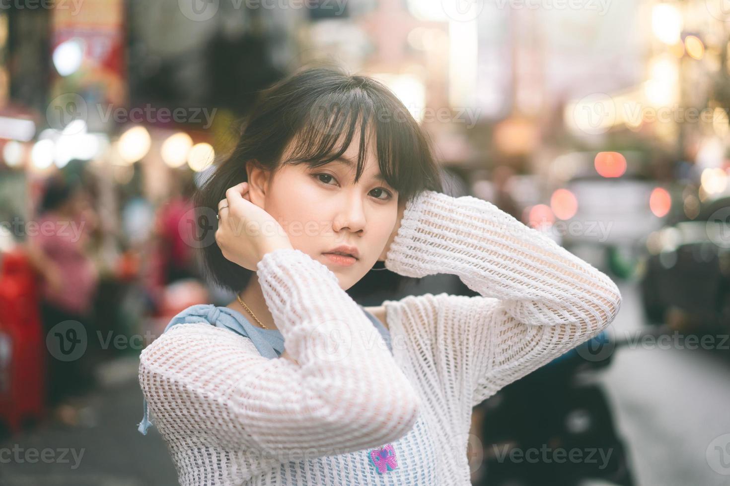 Portrait of young adult asian woman with 80s style japanese fashion at city outdoor photo