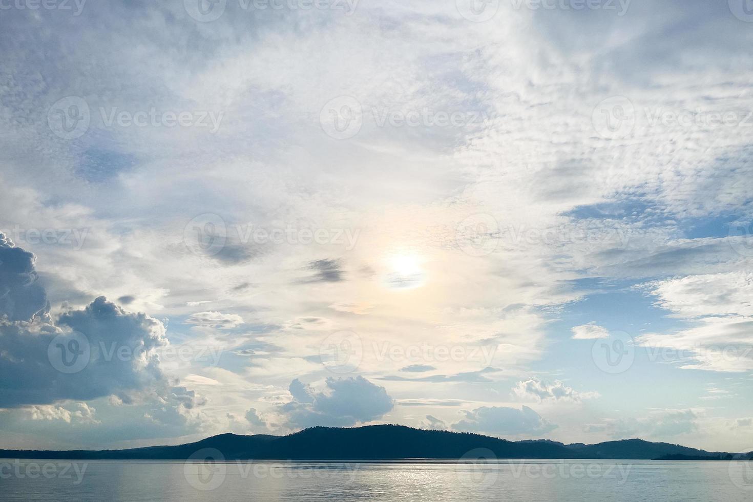 the shoreline of the river in the rays of the sun photo