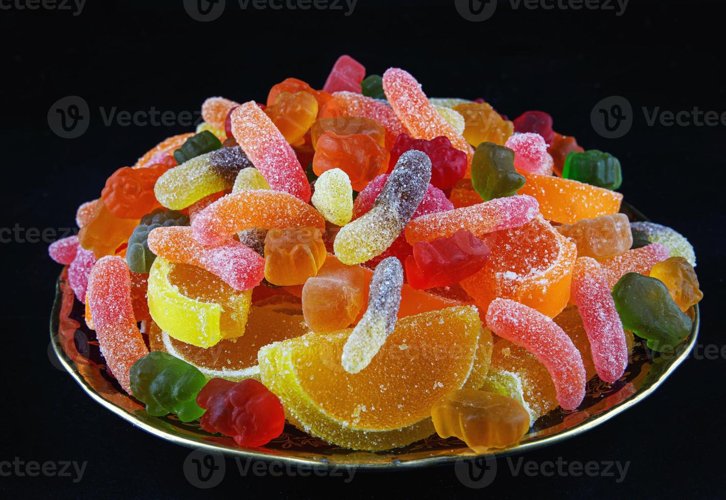 A full plate of colorful marmalade candy. a top view. Marmalade background. photo