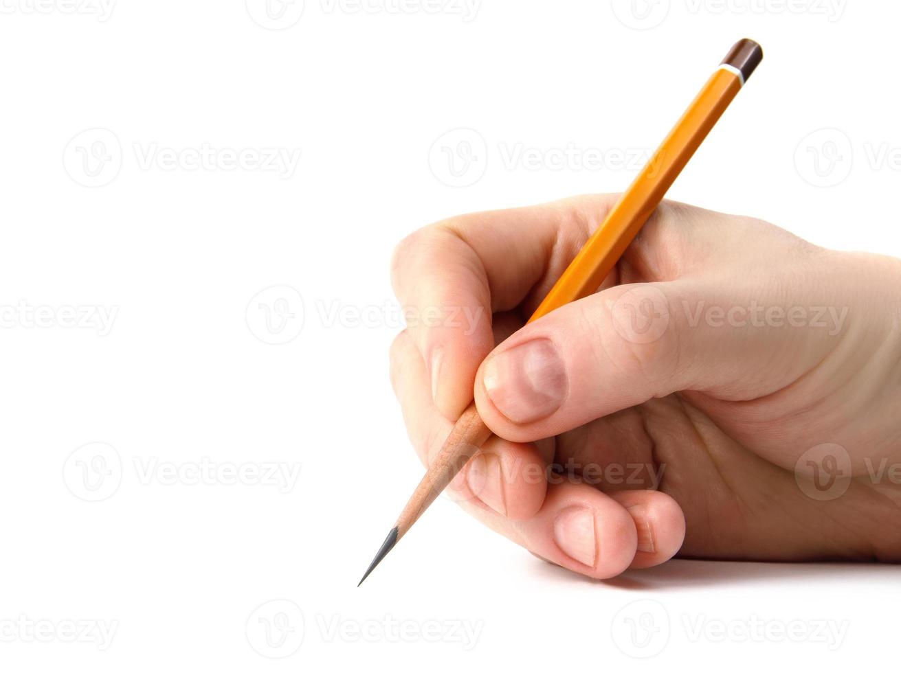 The hand holds an acutely sharpened pencil. photo